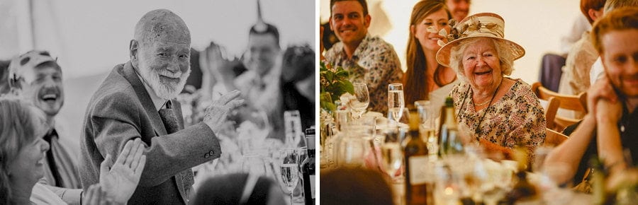 The brides grandparents smile as they sit at the wedding table