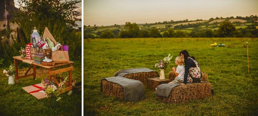 A mother and son sits on a bail and watch the sun go down at Penny Square Barn
