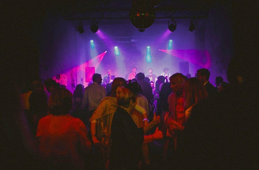 The brides sister hugs a friend on the dancefloor