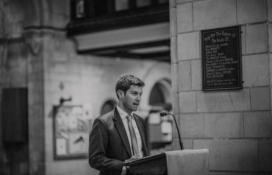 A wedding guest delivers his speech in church