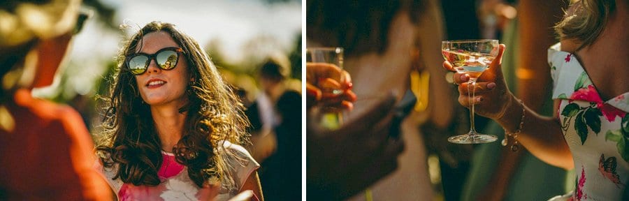 A champagne glass and a wedding guest chats with friends
