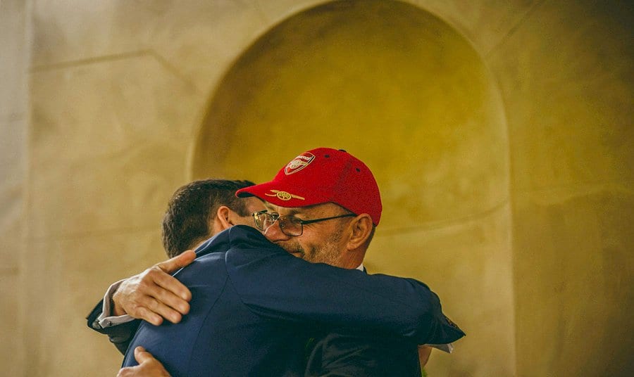 The brides father hugs the groom after he finishes his wedding speech
