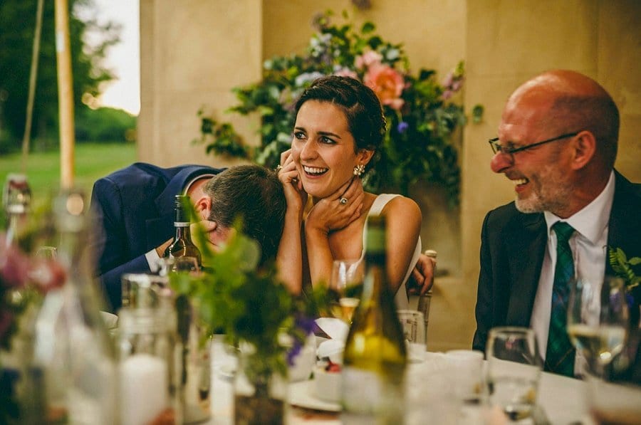 The groom lowers head as he listens to the best mans speech