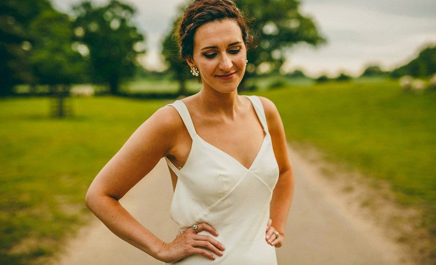 A portrait of the bride stood in the grounds of Wilderness Reserve in Suffolk