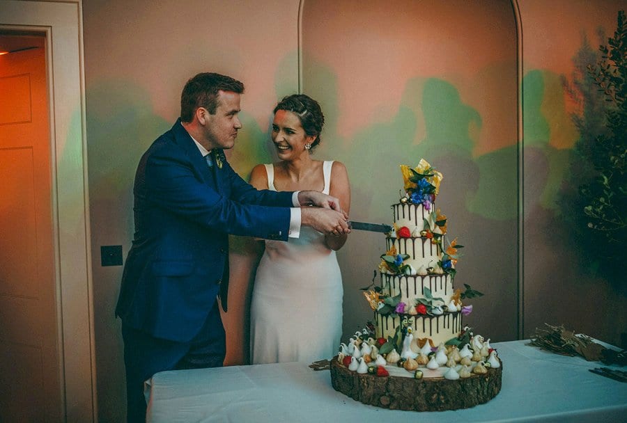The bride and groom cut the wedding cake