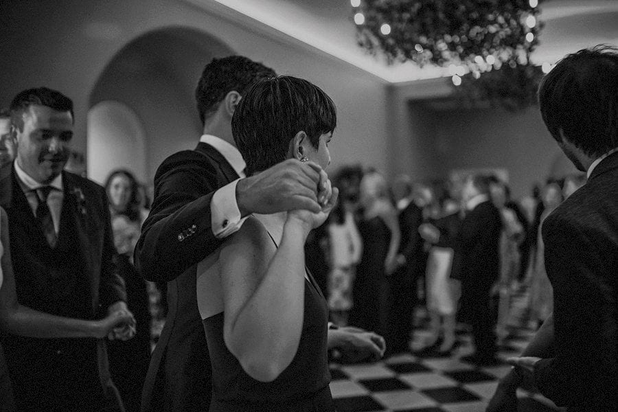 A couple hold hands on the dancefloor