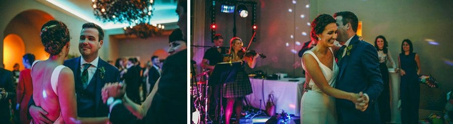 The bride and groom hold hands on the dance floor