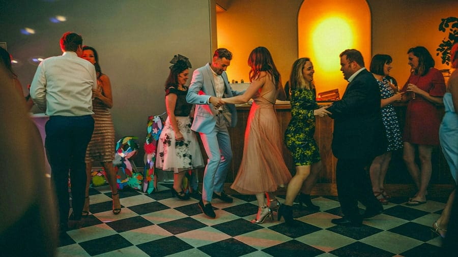 A man dances next to the bar with his wife