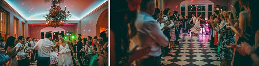 The wedding party clap as the bride and groom dance