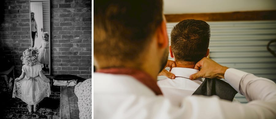 The flower girl looks in the mirror and an usher straightens the grooms collar