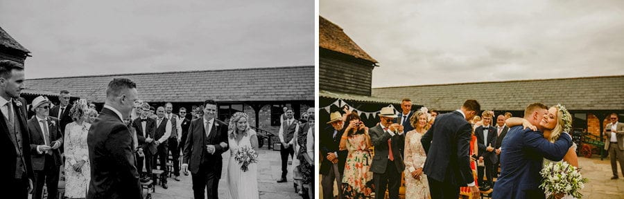 The bride and groom greet each other in the courtyard at Over Barn