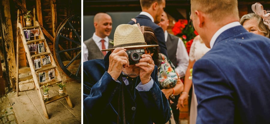 The grooms grandfather takes a photograph with an old film camera of his grandson