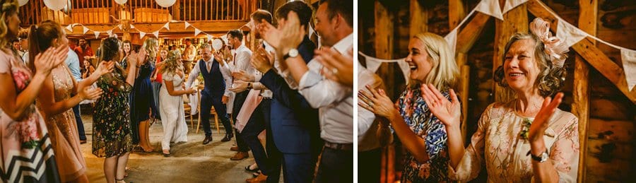 The bride and groom dancing at Over Barn while the wedding guests gather round