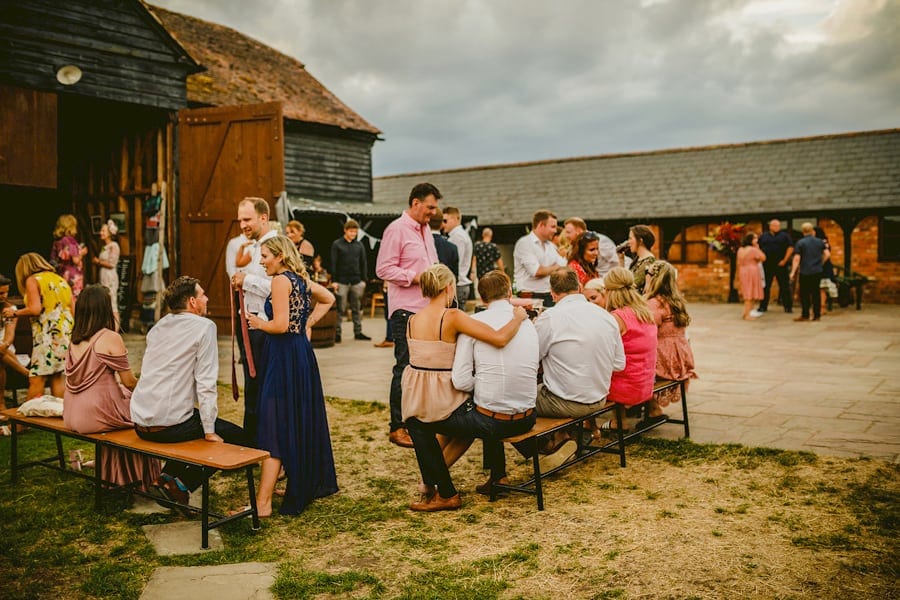 Wedding guests congregate in the courtyard at Over Barn