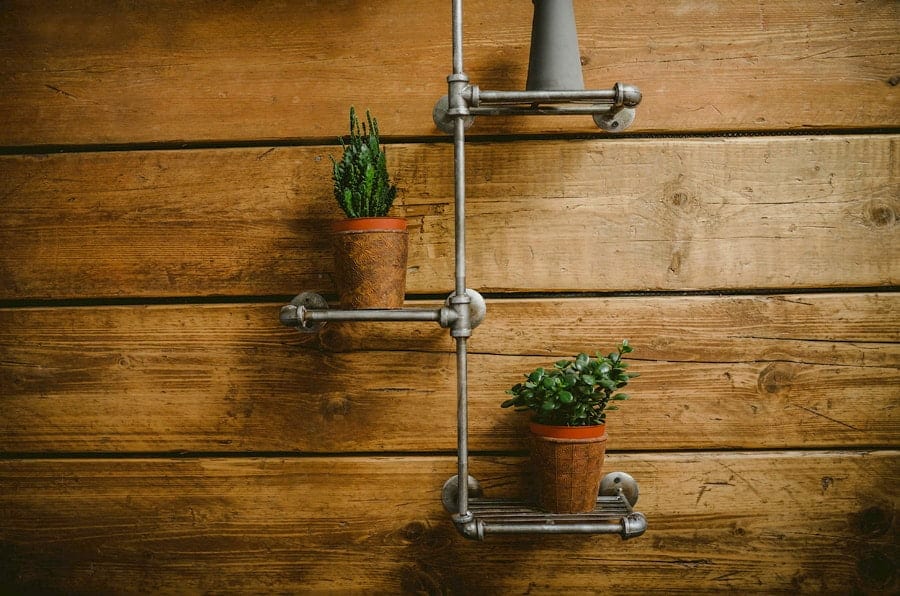 Two small pots with plants in them hang from a wall at the yurt retreat in Crewkerne, Somerset