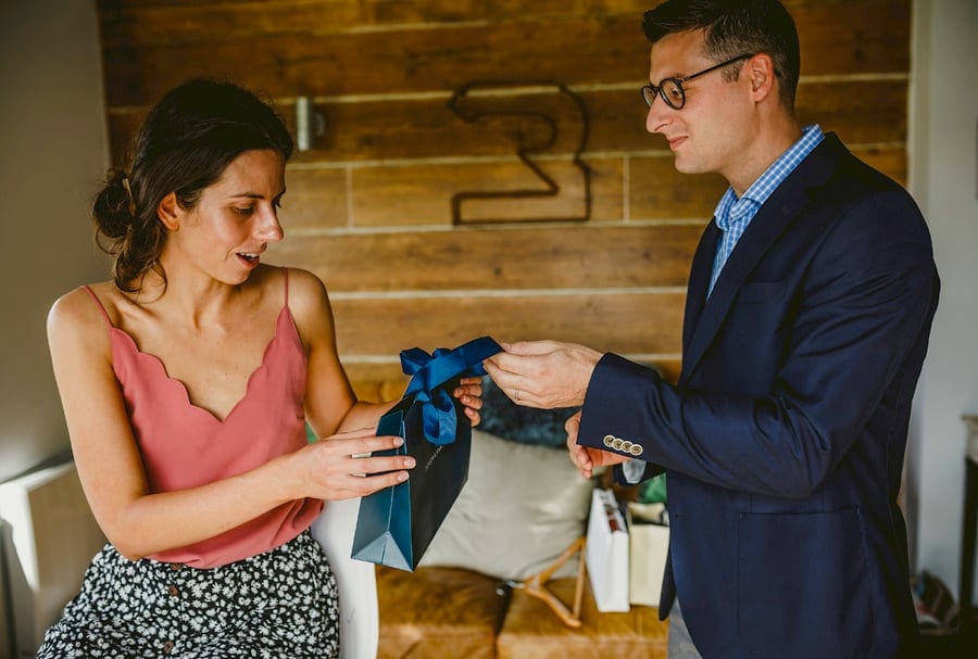 A man gives the bride a wedding gift in the cottage