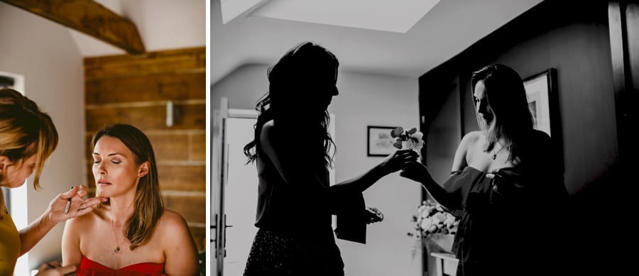 A bridesmaid gives the bride a flower in the hallway of the cottage