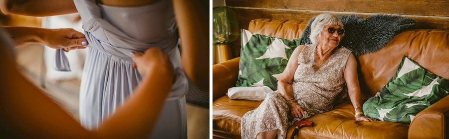 A bridesmaid ties the straps at the back of one of the bridesmaids dresses