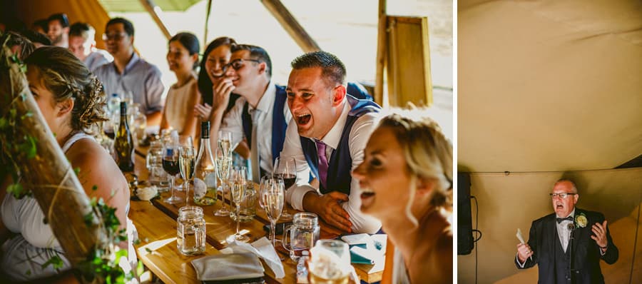 Wedding guests laugh at the brides fathers wedding speech in the tipi