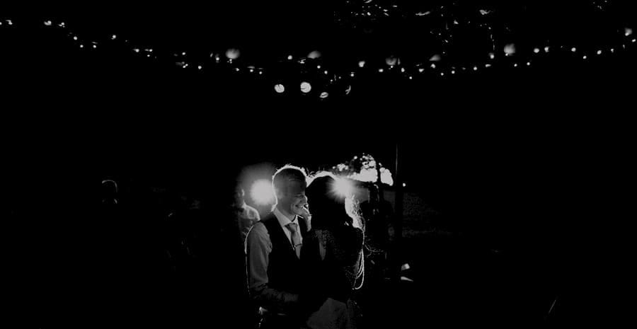The bride and groom dance with each other on the dancefloor in the tipi at yurt retreat