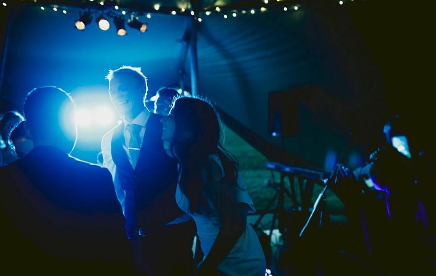 The bride dances with the groom on the dancefloor