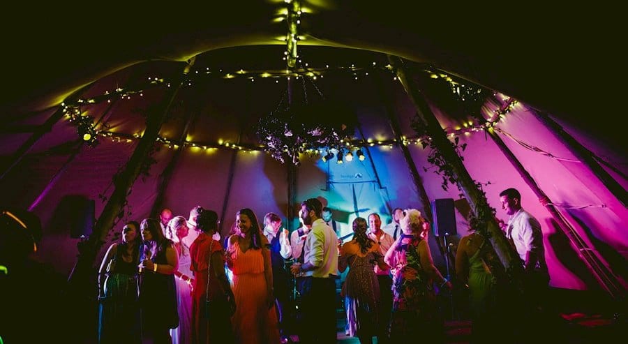 Wedding guests on the dancefloor in the tipi at yurt retreat