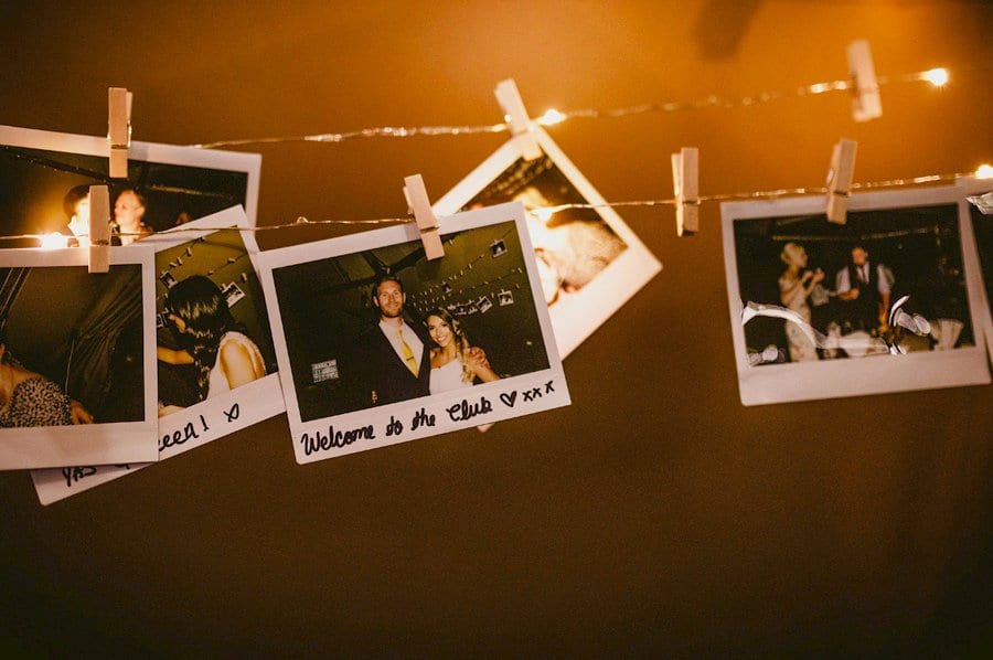 Polaroid photographs hang on string in the tipi