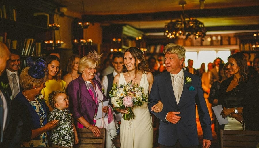 The bride and her father walk down the aisle at Abbey House Gardens