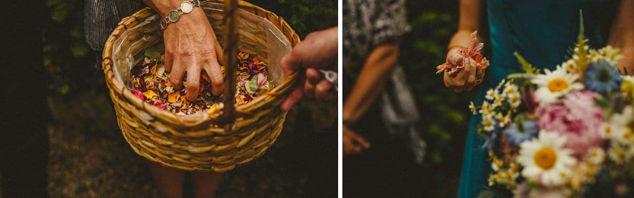 Wedding guests pick up confetti from a wicker basket outside the house