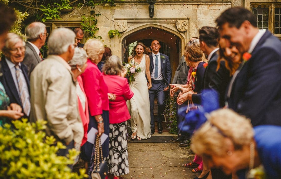 The bride and groom leave the house at Abbey House Gardens and are showered in confetti