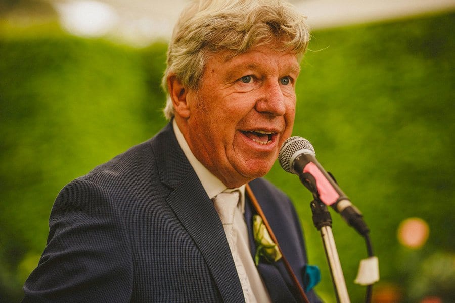 The bride's father plays guitar and sings a song