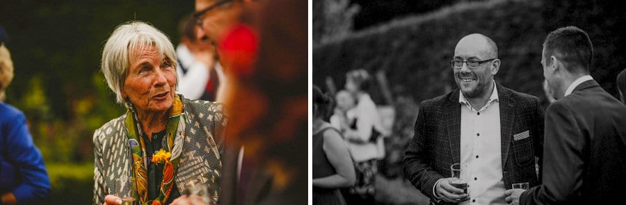 Wedding guests chat amongst each other in the gardens at Abbey House