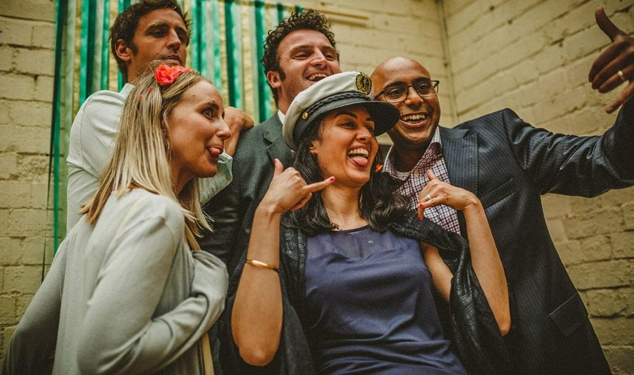 Wedding guests poses for a photograph in the photo booth