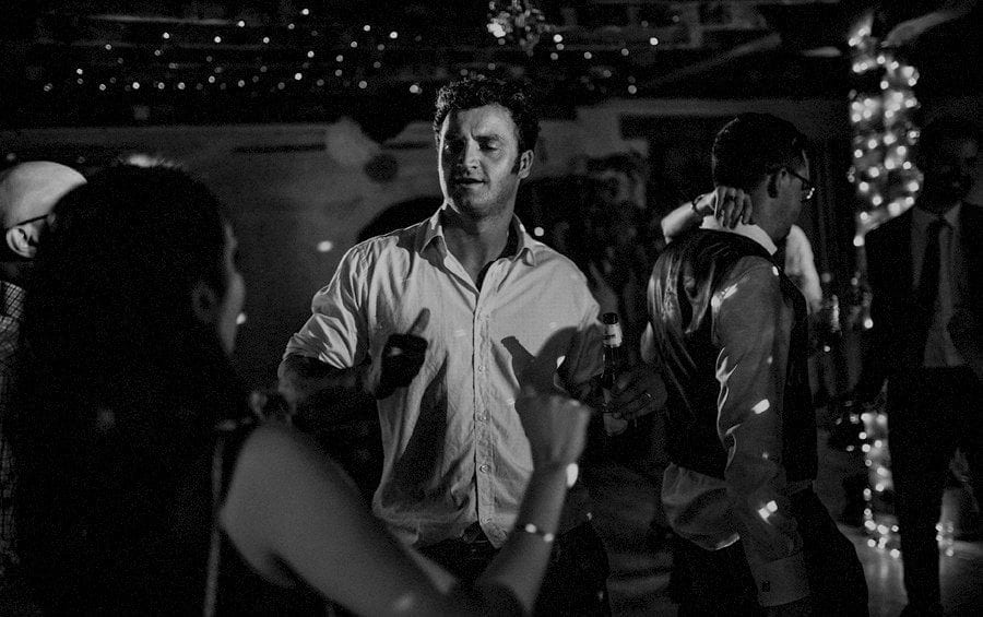 A wedding guest dancing with his wife