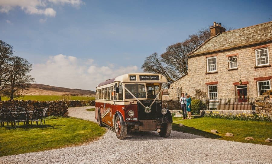 The wedding bus arrives outside the cottage