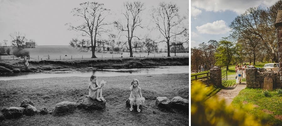 Two little girls sit on rocks in the garden of the Church