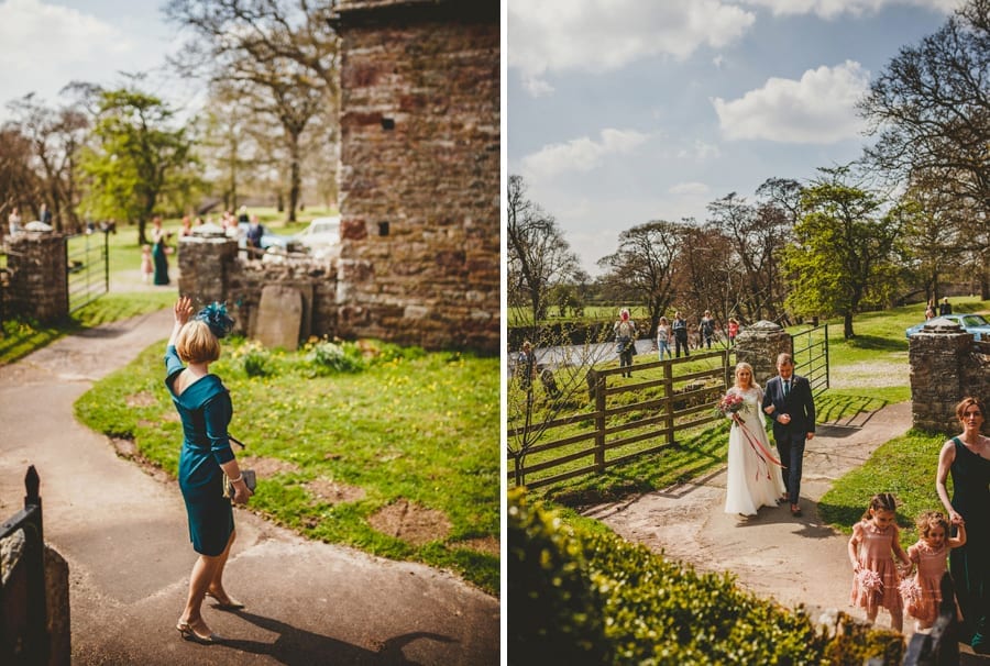 The mother of the bride waves at her husband and daughter and the bride and her father walk towards the Church