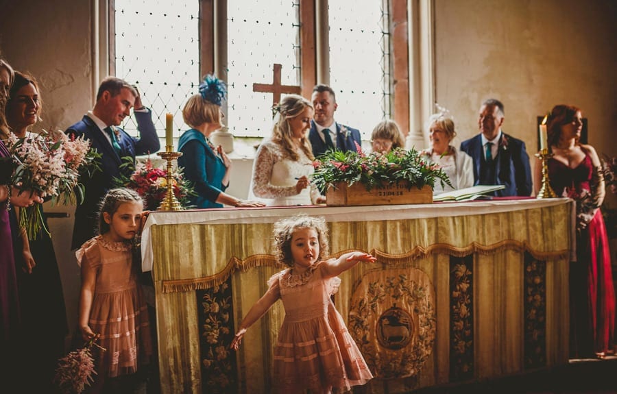 The wedding party sign the register in the Church