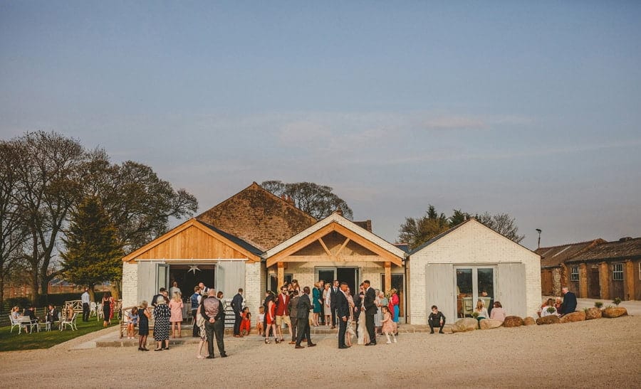 Wedding guests outside Eden Barn in Little Musgrave, Cumbria