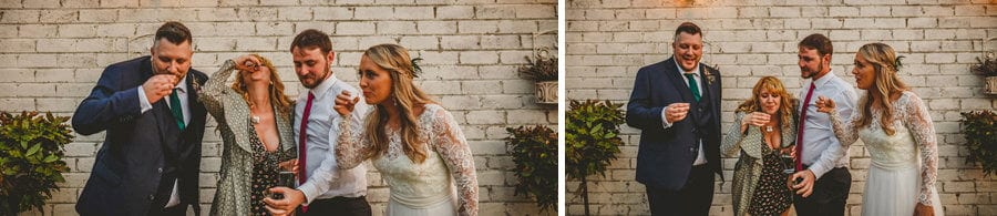 The bride and groom drink shots of alcohol with friends