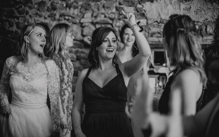 A bridesmaid dancing on the dancefloor in Eden Barn