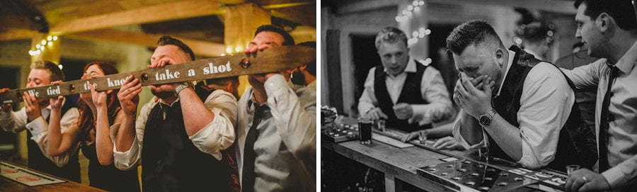The groom and his ushers drink alcoholic shots at the bar in Eden Barn