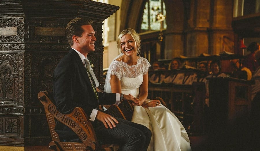 The bride laughs with the groom during the wedding ceremony