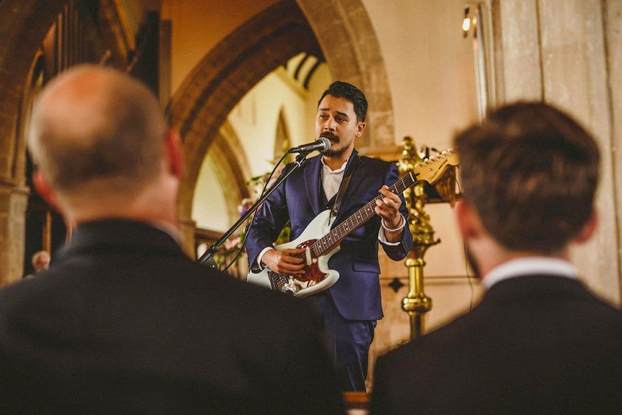 One of the wedding guests plays a song in church