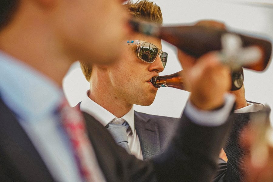 Wedding guests drinking bottles of beer