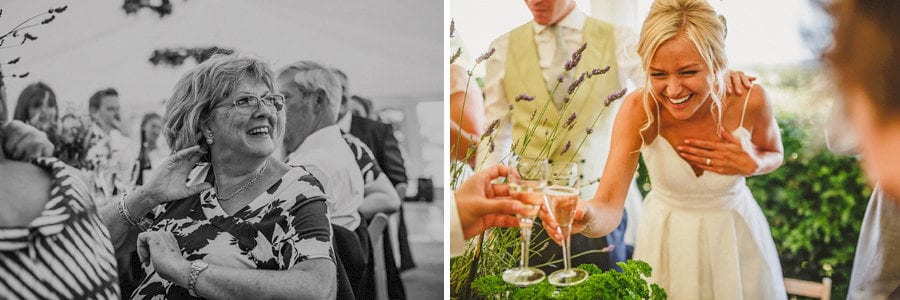The bride laughs as she raises a glass with a member of her family
