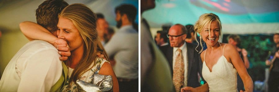 A member of the wedding party embraces her husband on the dancefloor