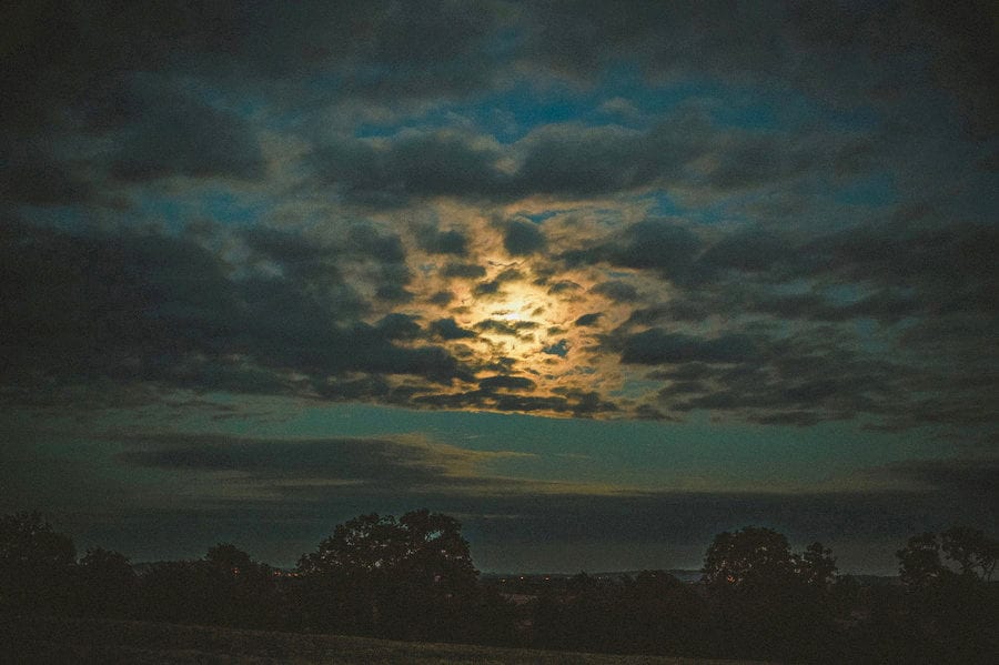 The moon is filtered by the clouds over the Somerset levels
