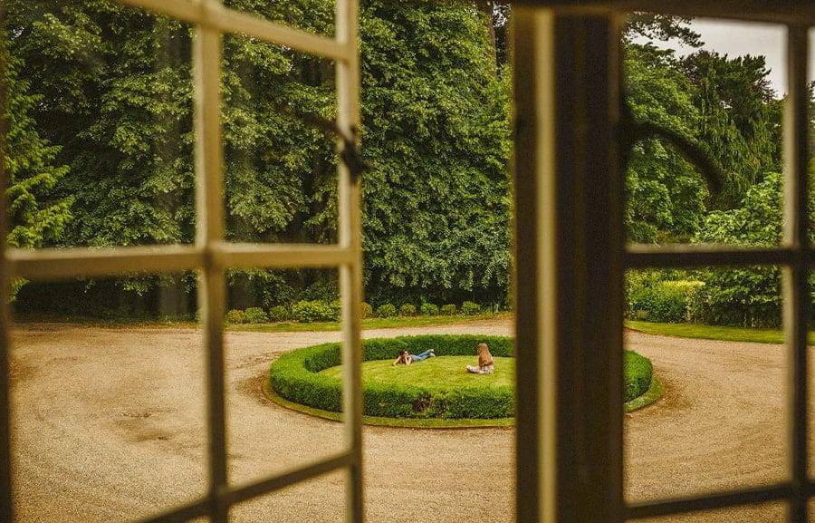 Children lie on the grass outside Voewood House