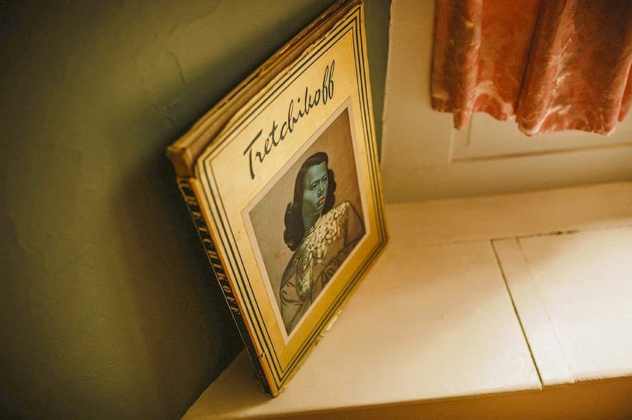 An old book lies next to the window in the groom's suite